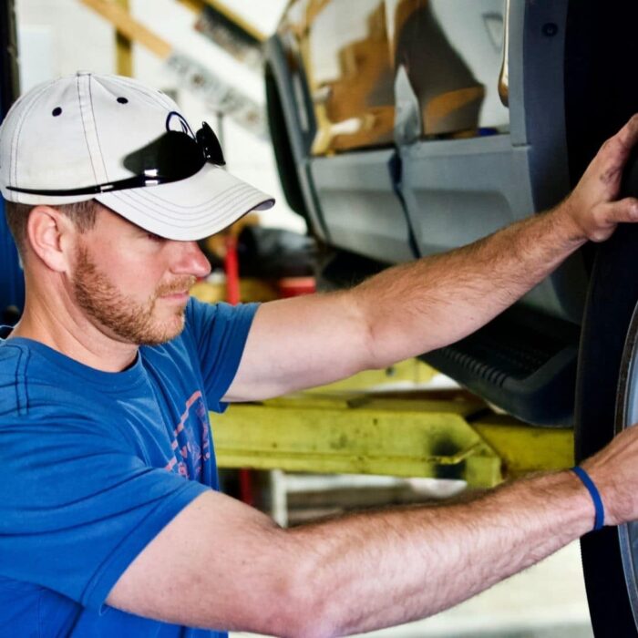 A 4-bay garage is outfitted with 2 hydraulic lifts.